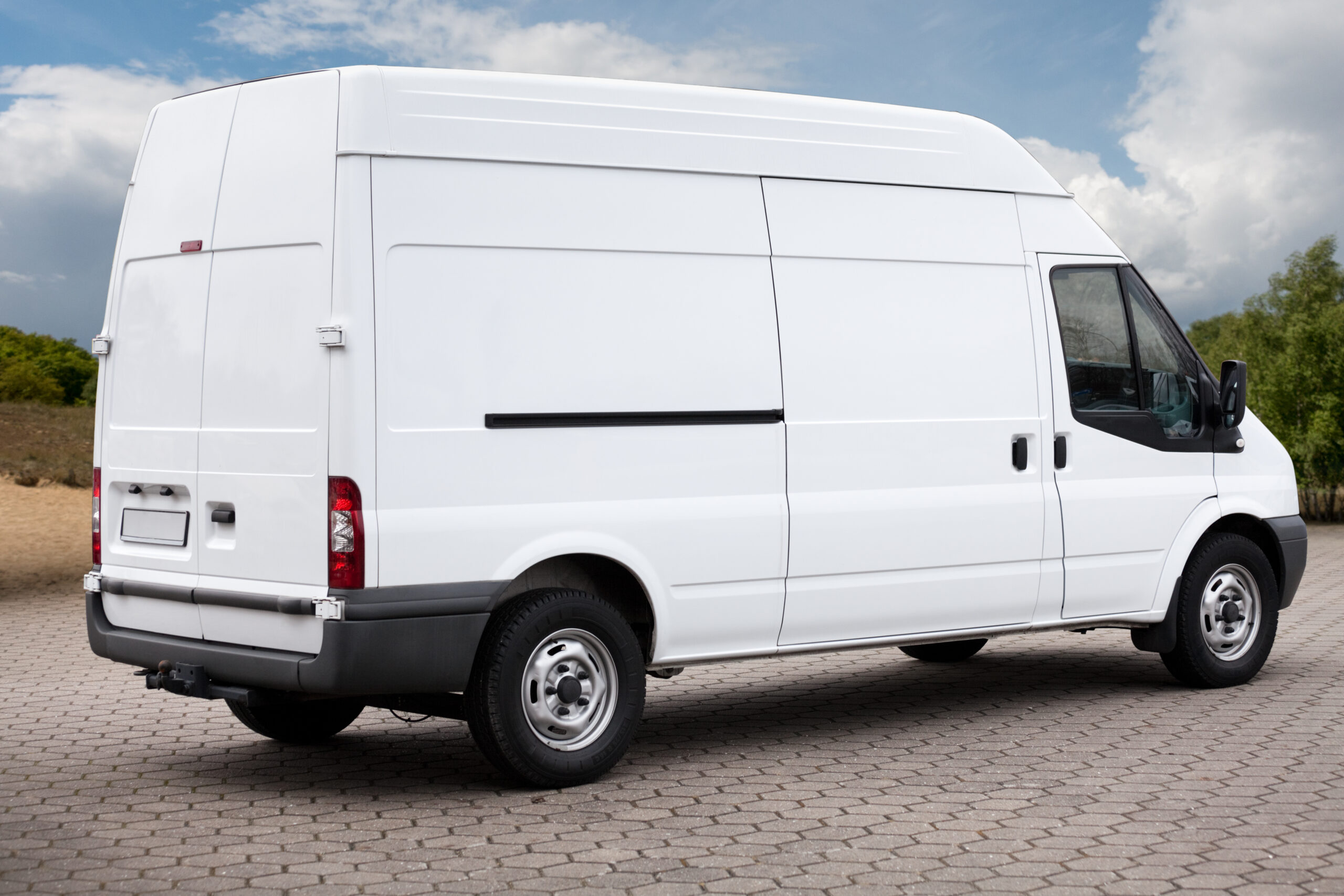 Plain white van parking outdoors